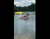 Red shorts guy push ups board lake 