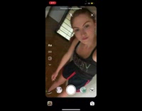 Woman is bent over in low ceiling apartment