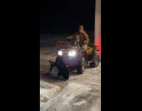 Dog rides snow blower to remove snow
