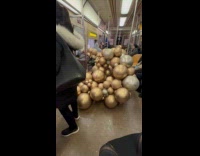 Woman transport balloon arch rides the subway