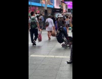 Collab WINY - Woman carrying mannequin head at Times Square
