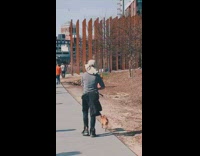 Lady walks dog plays violin fisherman hat