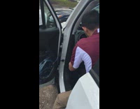 Friend sneaks up behind and catches guy sings Selena Gomez song while fixing car in drivers seat
