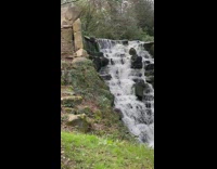 Man in black jacket rap by the waterfalls