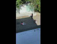 Man in pink shirt yoga pose in the street