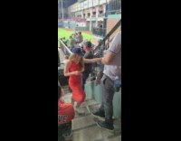 Woman in orange dress at the baseball stadium