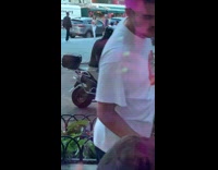 Man sit motorcycle put pizza box sideways