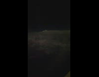 Storm clouds flashing lights night plane view