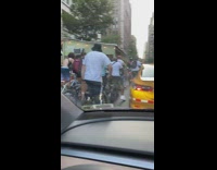 Lot of bikers along the street with other vehicles at day 