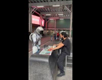Guy on spacesuit plays chess at street