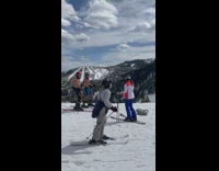 Two Shirtless Guys Pose in the Snow with Ski Gear