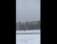 Guy walking in snowstorm with no shirt and only shorts