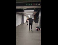 Two ladies films dance video at station