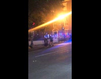 Girl dances by white cop car lights 