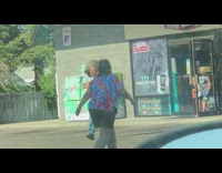 Man walks outside with a raccoon on its shoulder