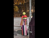 Woman stripes outfit poses inside the mosque