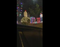 Man film music video at christmas decorations