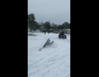 Tractor pulls guy on black snowboard fail 