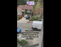 Woman pink shorts dance tiktok video outside house