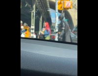 Batman waits patiently to cross the street