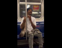 Man on subway train with pet python