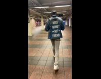Collab winy - Man  walk in subway jacket with text on back 