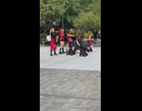 Girl dance group red black clothes park