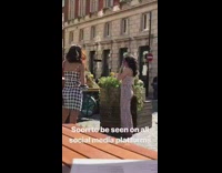 Girl striped romper in front of plants checkered dress