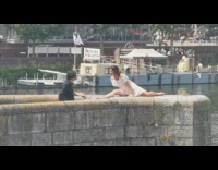 Woman white dress split legs stone ledge