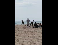 Girl black jumpsuit dance and throw sand