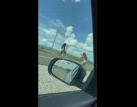 Woman holds her handbag in front of the Prada store
