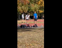 Man at park playing hacky sack