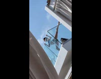 Woman bikini stretches legs for balcony photo Part 2