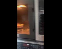 High man puts empty box on microwave