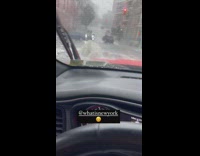 Person driving car pass by overflowing manhole