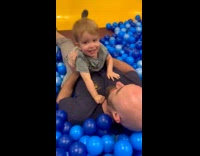 Kid rides father and slides ball pit