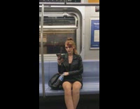 Woman has special effects blood wound make up on her face on subway train