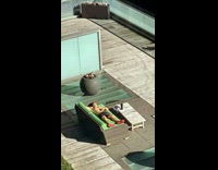 Shirtless guy lays on rooftop touching his abs 