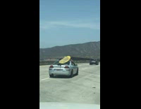 Collab Kook Of The Day - yellow surf board on grey silver car roof