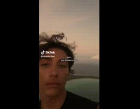 Man Shows Mountain Peak View on Island