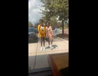 Two girls one way window pink skirt 