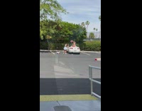 Two girls on convertible car pink hat