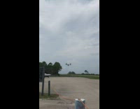 Girl watches low flying airplane orange rope 