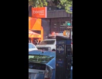 People watch car burn on the street