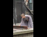 Woman Wearing Long Dress Smokes Cigarette 