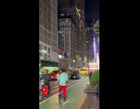 Man ride bike on street carry TV