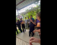 Man slides on inflatable lands on man