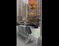 Guy pose beside broken hanging pedestrian traffic light