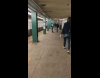 Guy Skateboards with a Stick at Station 