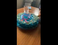 Guy cuts blue cake with scissors